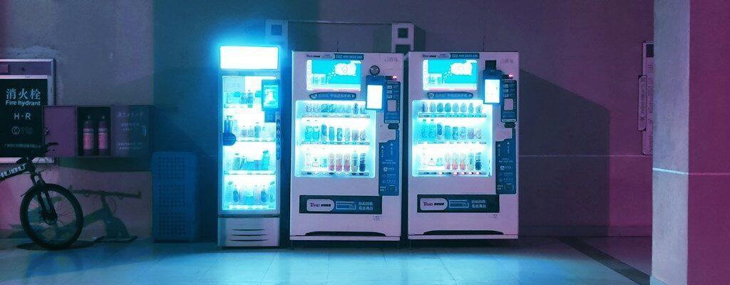 a couple of vending machines sitting on the side of a road